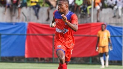 LISCR FC midfielder Sabastin Teclar in red kit dribbling the ball during a league match