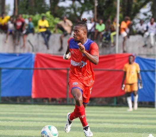 LISCR FC midfielder Sabastin Teclar in red kit dribbling the ball during a league match