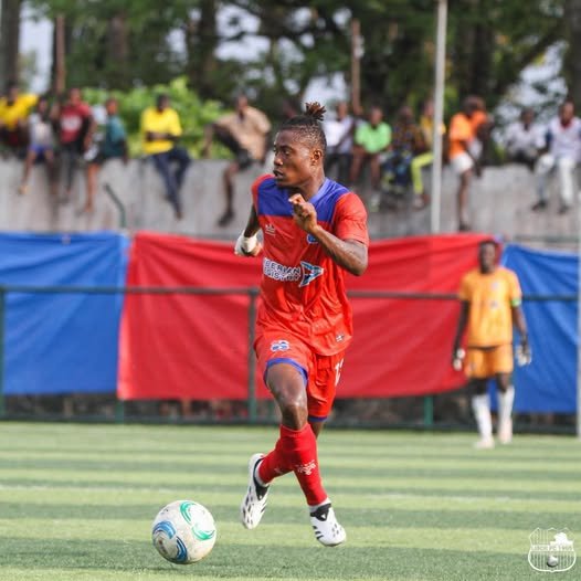 LISCR FC midfielder Sabastin Teclar in red kit dribbling the ball during a league match